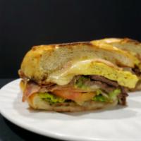 Cubana Torta · Sandwich with grilled carne asada, melted jack, cheddar cheese, 2 eggs, ham, lettuce, tomato...