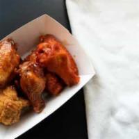 Boneless Wings to Share · Cooked boneless wings of a chicken coated in sauce or seasoning. 