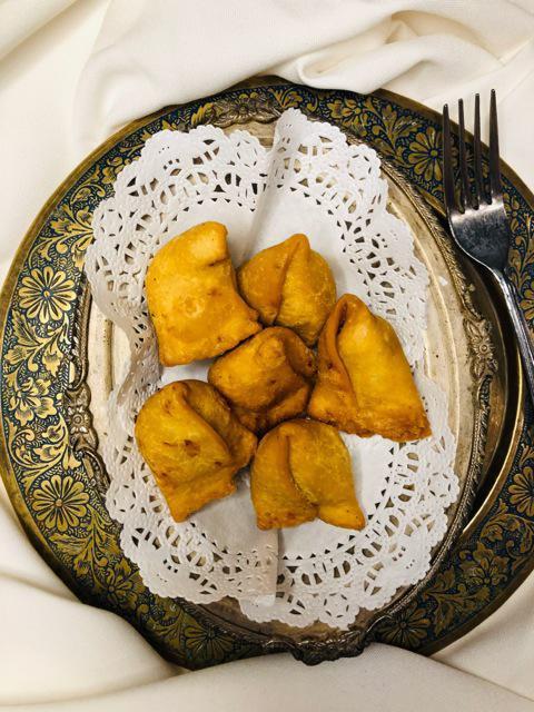 Samosas · Crispy turnovers filled with lightly spiced potatoes and green peas.