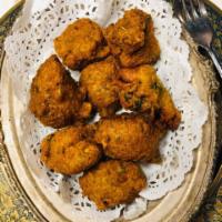 Chili Cheese Pakora · Crispy spiced paneer and green chili lentil fritters.