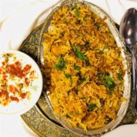 Chicken Biriyani with Raita · Basmati rice cooked with saffron, herbs, and chicken. Served with raitha - yogurt mixed with...