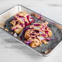 Baja Fish Taco · 2 pieces. Beer battered mahi mahi, pickled red onion, red cabbage, and roasted jalapeno mayo.