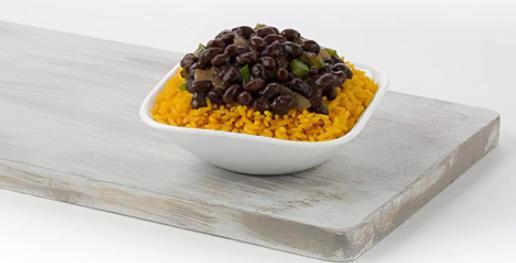 Rice & Beans · Where else are you going to get traditional black beans and yellow rice? Our black beans are stewed in a broth seasoned with bay leaves and diced green bell peppers and onions, and are served over a bed of yellow rice. The perfect side dish – or a meal by itself. You decide.