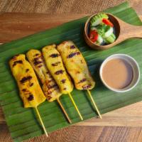 Chicken Satay · Grilled white meat chicken marinated in coconut milk and Thai spices, served with pickled cu...
