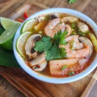 Tom Yum Soup · A Thai favorite, lemongrass soup, mushroom, tomato, cilantro, scallions, kaffir lime leaves,...