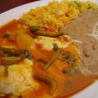 10. Huevos Rancheros · Two eggs, served on a corn tortilla topped with salsa ranchera, beans, Monterrey cheese, ric...