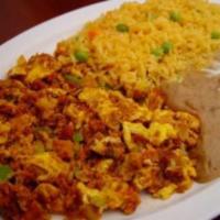 13. Huevos Con Chorizo · Chorizo pork sausage with two eggs, onions and bell pepper, with beans, cheese, rice and tor...