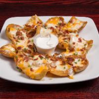 Sully's Potato Skins · Chunks of Idaho spuds, covered with Jack, cheddar and Parmesan cheeses, bacon and chives. Se...