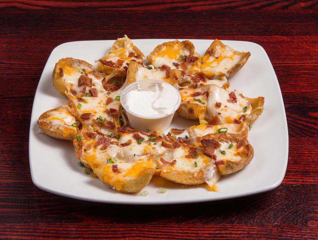 Sully's Potato Skins · Chunks of Idaho spuds, covered with Jack, cheddar and Parmesan cheeses, bacon and chives. Served with a side of sour cream.