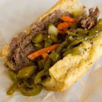 Italian Beef Sandwich · Italian beef on a bun dipped in a sauce with cheese and giardiniera or banana pepper.