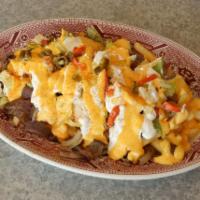 Nachos Gangster · 4 meat: gyro meat, Italian beef, corn beef &, philly steak, lettuce, tomato and nacho cheese.