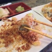 Crunchy Roll · 8 pieces. 2 shrimp tempura, avocado, cucumber inside, tempura crumbs and eel sauce on top.