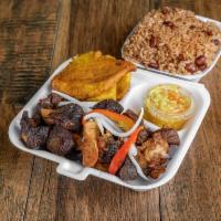 Tassot kabrit ( FRIED GOAT) complete · Tassot kabrit. Marinated fried goat. Served with fried plantains and rice ad peas .