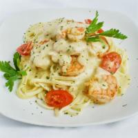 Shrimp Pasta Alfredo · Fettuccine pasta in a rich Parmesan cheese and butter Alfredo sauce tossed with shrimp.