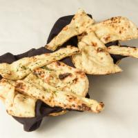 Naan · Flat leavened bread baked on the wall lining of the tandoori oven.