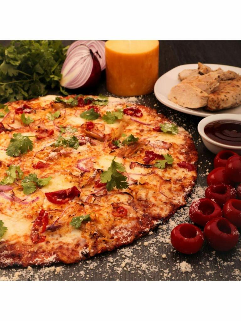 BBQ Chicken Pizza · Roasted chicken, BBQ sauce, smoked mozzarella, peppadews, red onions, cilantro.