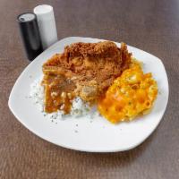 Pork Chops Special · Two crispy fried pork chops with sides and bread.