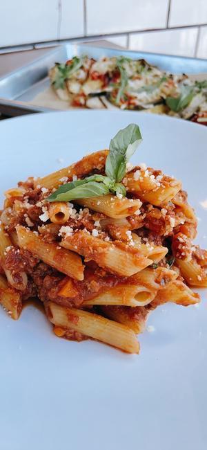PENNE BOLOGNESE · Penne pasta sauteed in meatless meat sauce, parmesan cheese and basil