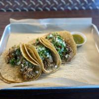 Tacos · 3 pieces warm corn tortilla with onions, cilantro, green sauce, and choice of pork or chicken.