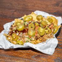 BBQ Nachos · Crispy tortilla chips layered with smoked pulled pork or pulled chicken, cheese, pico de gal...