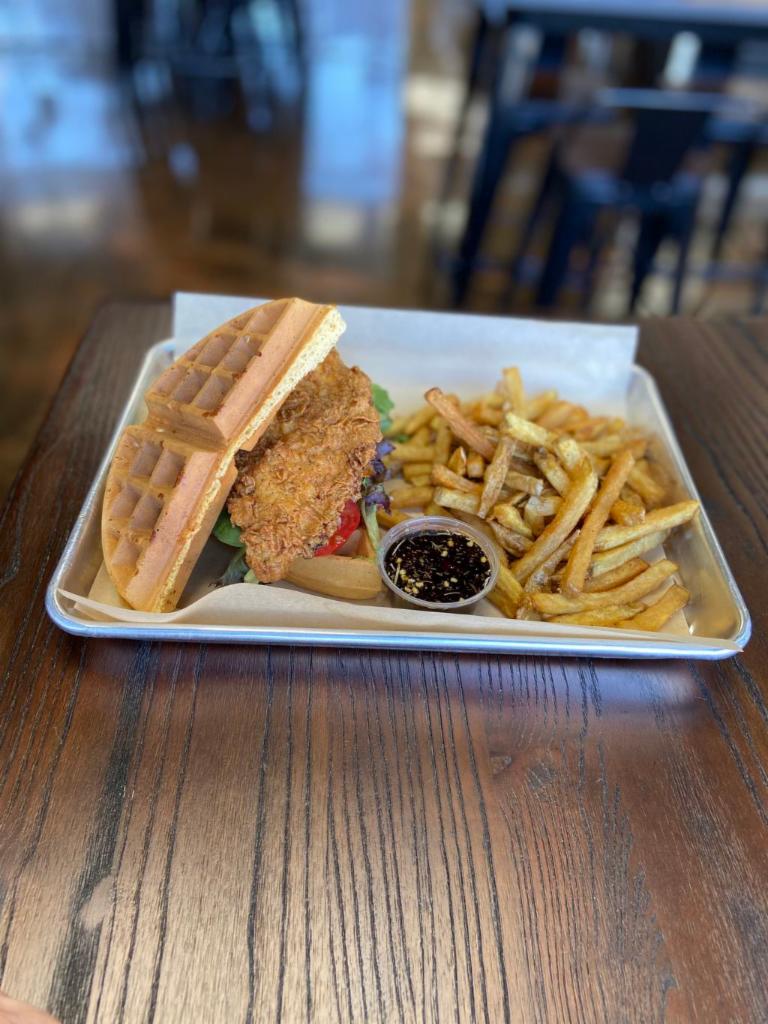 Chicken Waffle Sandwich · Buttermilk battered fried chicken breast in a Belgian waffle with lettuce, tomato, and onions drizzled in a special spicy syrup.