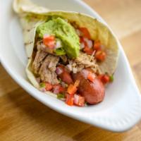 Baja Carnitas Dog · Grilled Everett's hot dog topped with spicy carnitas, guacamole, pico de gallo and a squeeze...