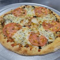 Margherita  · Pesto and olive oil base, fresh mozzarella, fresh basil, and tomatoes.
Pinch of salt added a...
