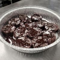 Ooey Gooey Brownies · 6 bite sized brownies with chocolate syrup and powdered sugar.