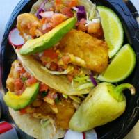 Baja-Style Fish Tacos · Baja-Style battered fish on a corn tortilla topped with our secret spread sauce, pico de gal...