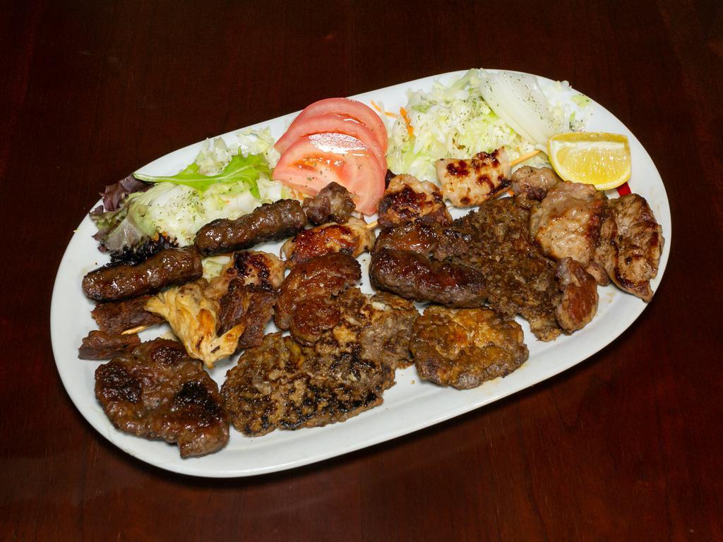 Veal Combination Plate · Veal shish kabob, veal sweetbreads, breaded veal brain, veal liver, cevapcici and hamburger. Served with ajvar (roasted red pepper spread), tomato, onion and cabbage salad.