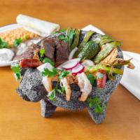 Molcajete Specialty · Grilled chicken, steak, shrimp, and chorizo, served in a molcajete bowl with panela cheese, ...