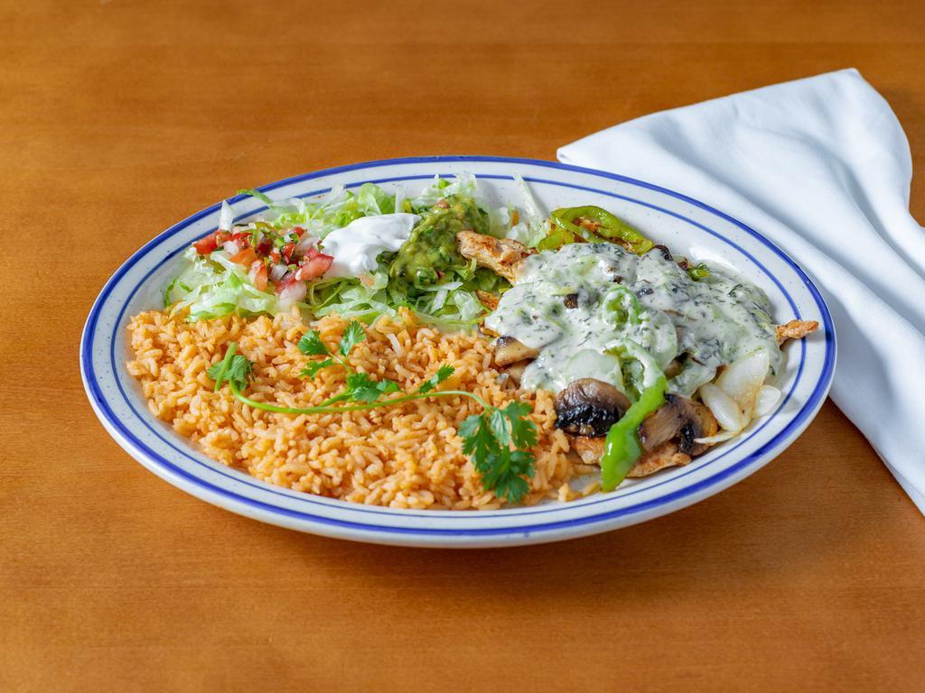 Pollo con Espinaca · Grilled chicken breast cooked with mushrooms, onion, and bell pepper on spinach sauce. Served with lettuce, tomatoes, guacamole, and rice.