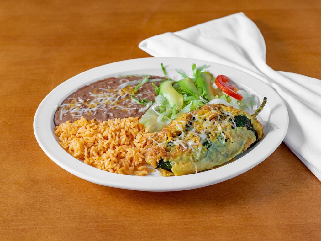 Chiles Rellene Lunch · 1 poblano pepper stuffed with cheese, covered with a spicy roasted tomato salsa and cheese, served with rice and beans.