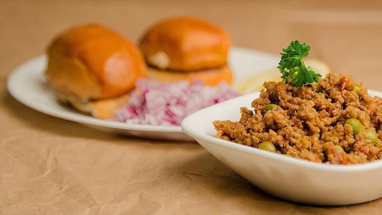 Kheema Pav · Popular street food in India, Robust, peppery curry dish made with minced lamb cooked with onion, tomatoes, ginger, garlic, and earthy spices! Served with lightly toasted pav bread laden with butter on the griddle