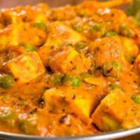 Mutter Paneer · Slow-cooked dish with peas and paneer in a tomato-based sauce spiced with masala. 