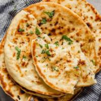 Jeera Naan · Naan pressed thin and garnished with cilantro and cumin seeds. Cooked in tandoor oven.