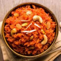 Carrot Halwa · Grated carrot-based sweet dessert pudding topped with ghee roasted almonds