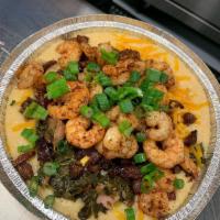 Gritsalicious · 1 of our signature dishescajun shrimp and andouille sausage collard greens, overtop our famo...
