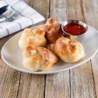 Garlic Knots · Four Dough knots brushed with garlic butter and topped with a generous sprinkle of parmesan ...