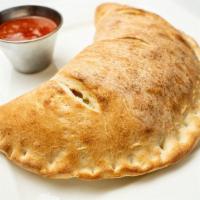 Meat Calzone · Fresh Dough stuffed with Homemade Meatballs, Sausage, Ham and mozzarella cheese. Served with...