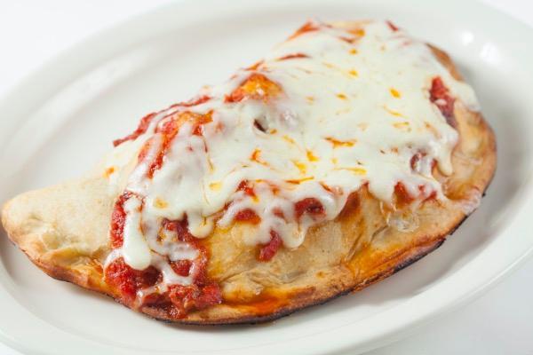 Pepperoni Calzone · Fresh dough stuffed with Pepperoni and Mozzarella cheese served with a side of homemade Marinara sauce