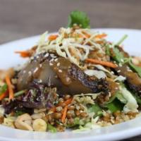 Sesame Portobello Grain Bowl · Grilled portobello mushrooms, peanuts and cashews on mixed greens and cabbage. Tossed with c...