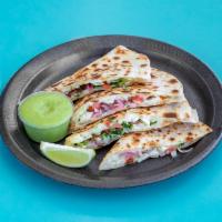 Veggie Quesadilla · Cooked tortilla that is filled with veggie and folded in half. 