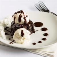 Chocolate Volcano Cake · Soft chocolate cake with hot chocolate ganache flowing from its centre, and served with Haag...