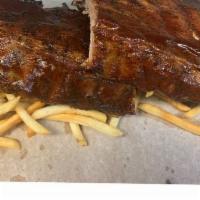 Full Rack Dinner · Full rack of in-house apple wood smoked Baby Back ribs, with your choice of sauce, a packet ...