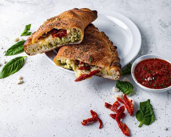 The Queen Calzone · Chicken, sundried tomato, basil pesto, feta, and mozzarella. Served with choice of dipping sauce.