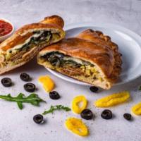 The King Calzone · Sausage, arugula, olives, banana peppers, basil pesto, and mozzarella. Served with choice of...