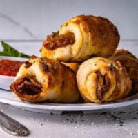Sausage Rolls · Sausage rolled in pizza dough baked and served with a side on tomato sauce.