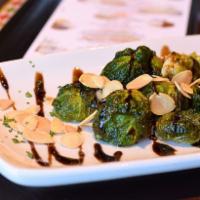 Crispy Brussels Sprouts · Tossed with almonds, garlic and balsamic glaze.