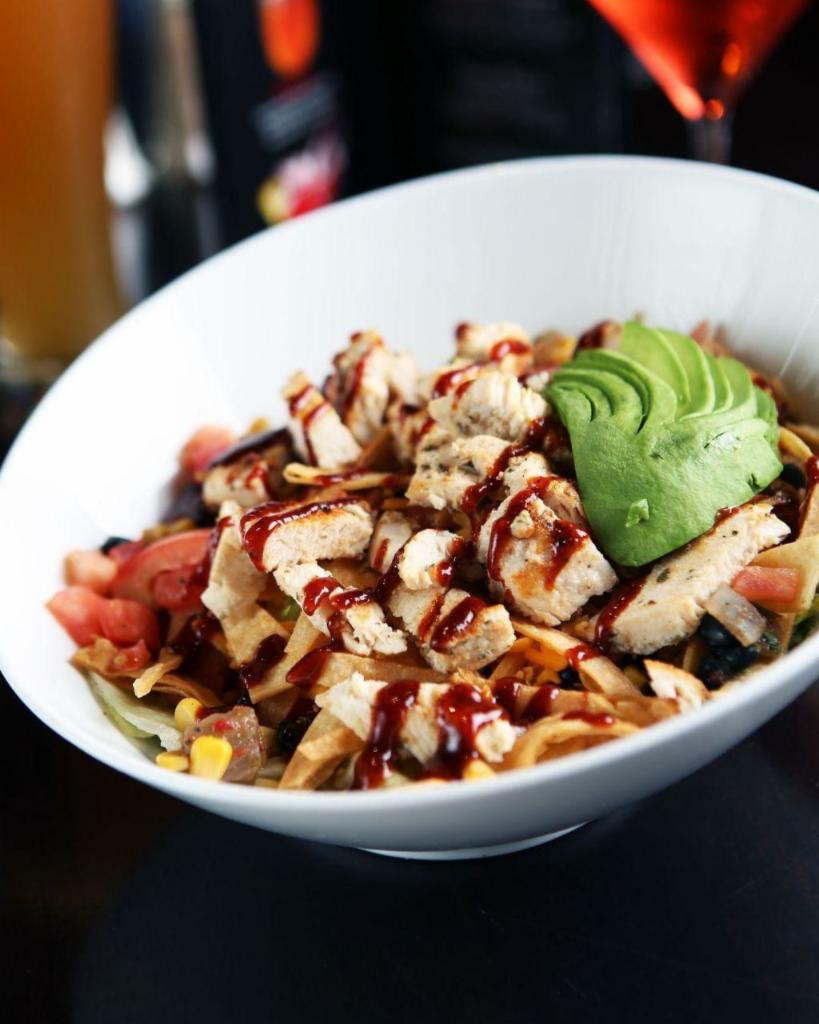 BBQ Chicken Chop Salad · Chopped garden blend with BBQ chicken breast, black bean and corn salsa, avocado, tomatoes, cheddar cheese, crispy tortilla strips and chipotle ranch dressing.